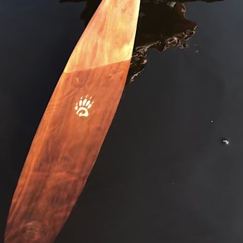 BADGER TRIPPER CHERRY CANOE PADDLE: The Essence of Paddling Perfection showing the paddle cut through the water